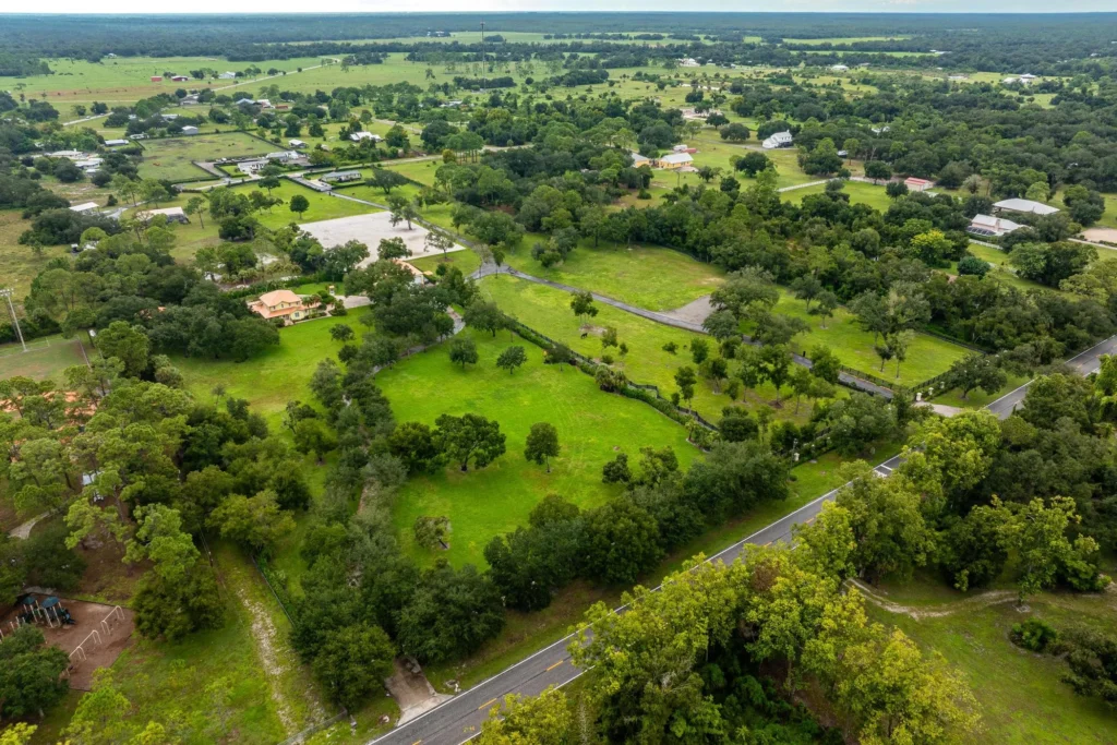 Aerial view of the acreage and surrounding landscape at 21571 N River Rd in Alva, Florida