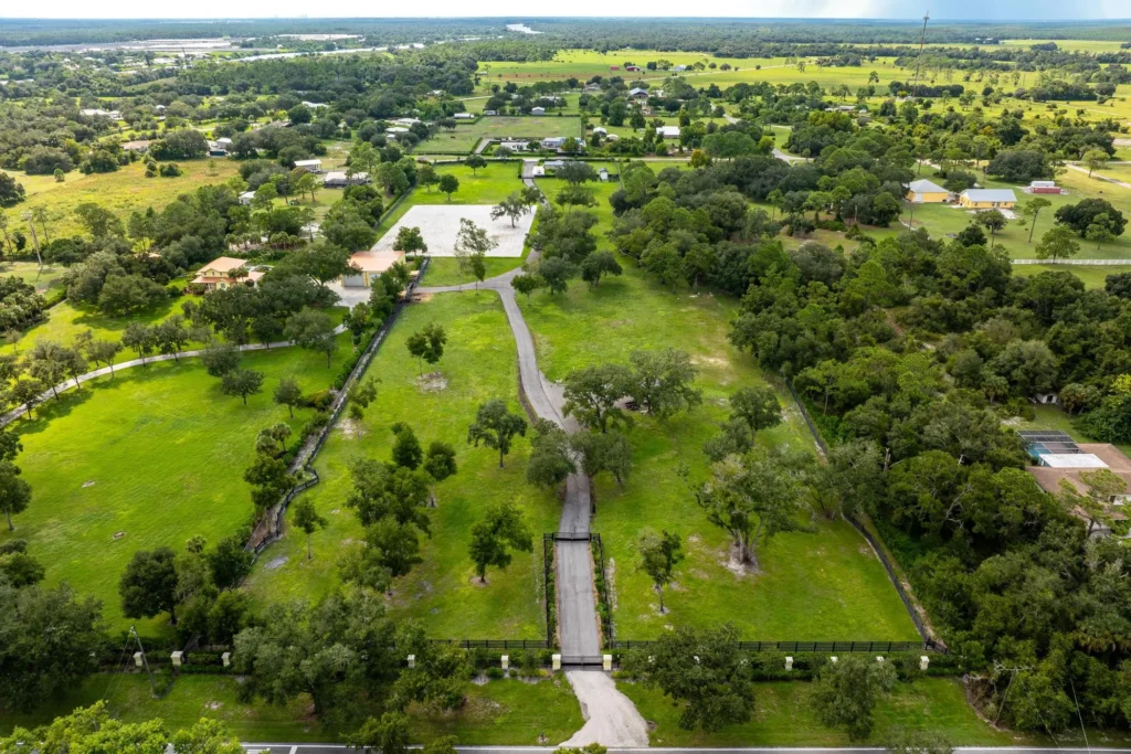 Aerial view of 21571 N River Rd in Alva, FL showing the gated property and surrounding acreage