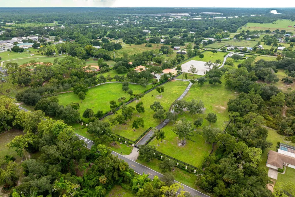 Aerial view of 21571 N River Rd in Alva, FL showing the expansive equestrian property and grounds